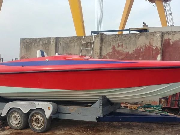 Lo stesso motoscafo riverniciato a spruzzo in rosso lucido, sullo stesso carrello